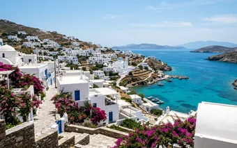 Whitewashed buildings and turquoise Aegean water on a quiet stretch of the Greek coast
