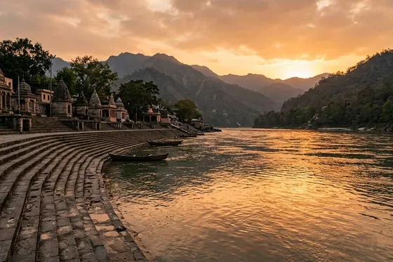 Sunset view of ghats and the Ganges River in Rishikesh, India, with Himalayan foothills behind