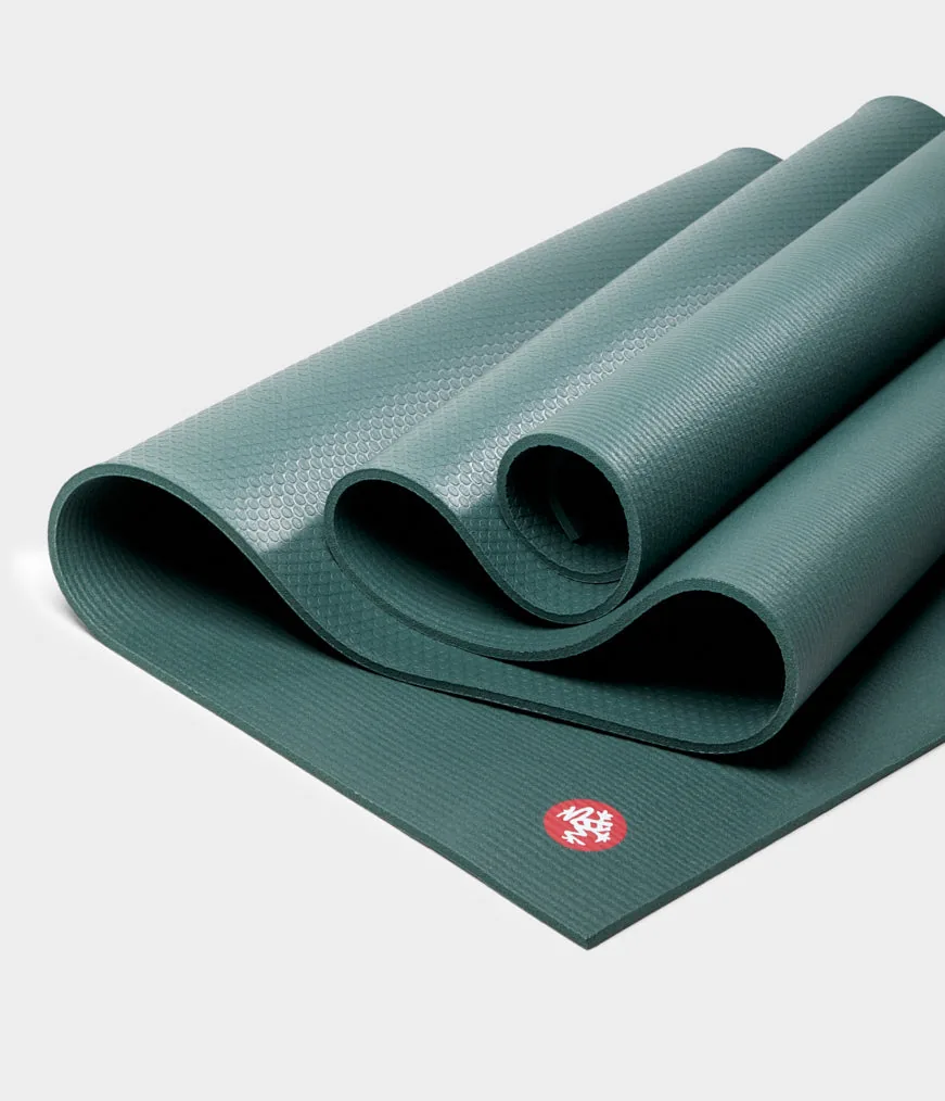 Manduka PRO mat folded to show the dot-pattern underside and the fabric-like top